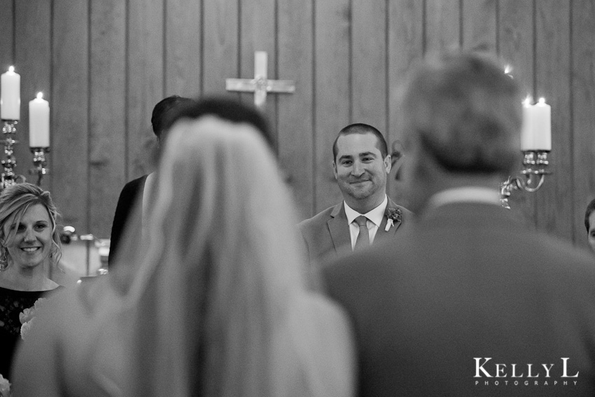 groom watches bride walk down aisle