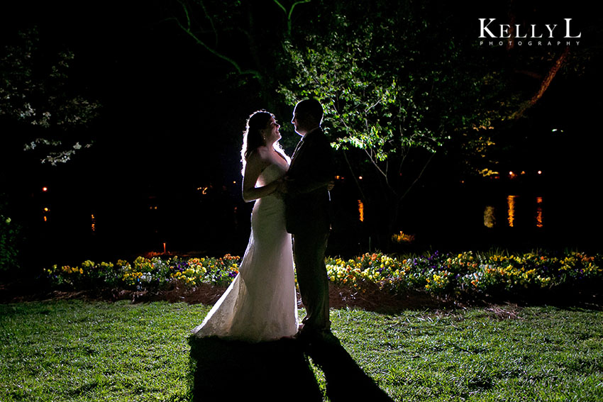 bride and groom by the river at night