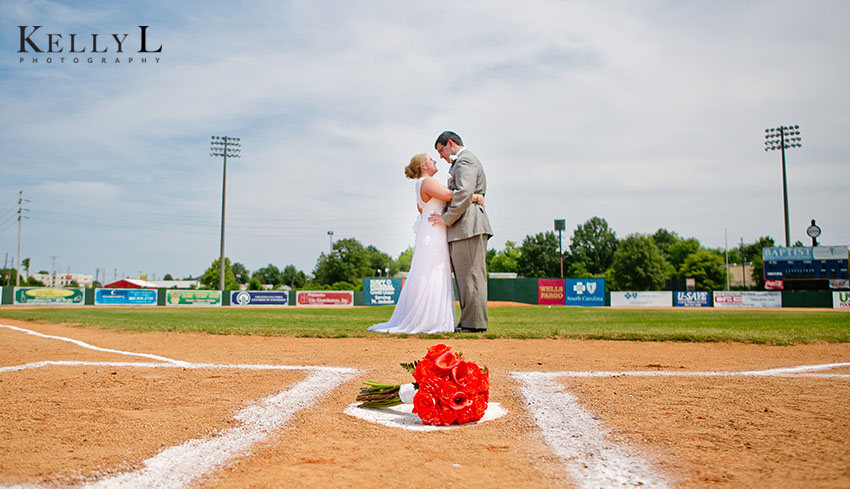 bride and groom at home plate