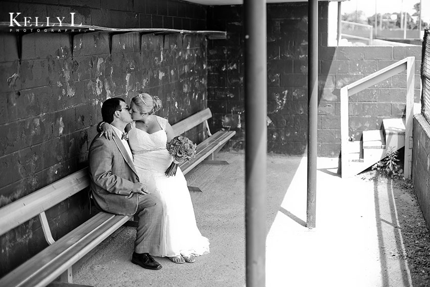 bride and groom in dugout