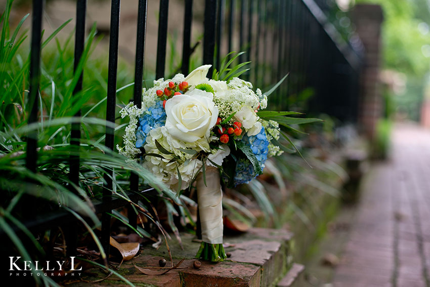bouquet with red blue and cream colored flowers
