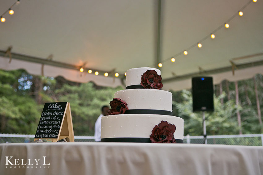 cake with black ribbon garnet flowers