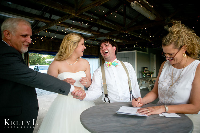 bride and groom sign their marriage license 