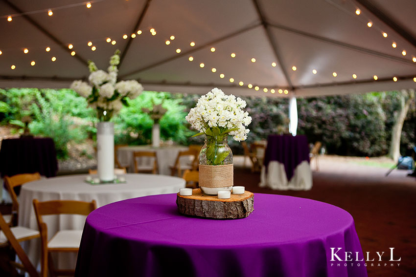 floral centerpiece in tent reception with purple colors