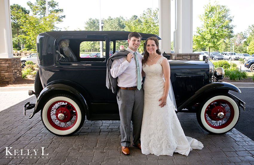 bride and groom with antique car