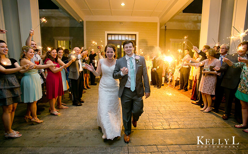 wedding guests send off bride and groom with sparklers