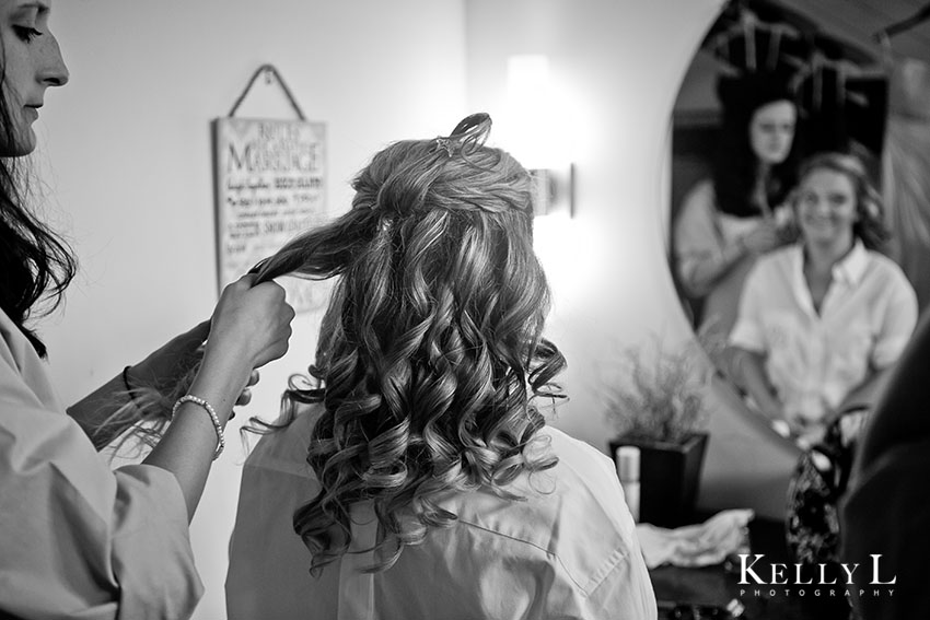 bride getting hair and makeup for wedding