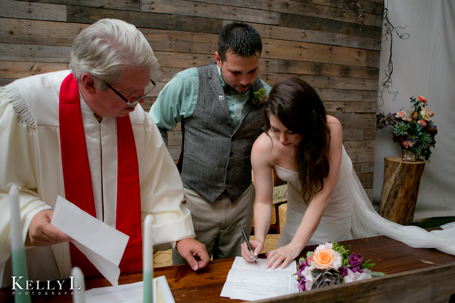 bride and groom sign the marriage license 