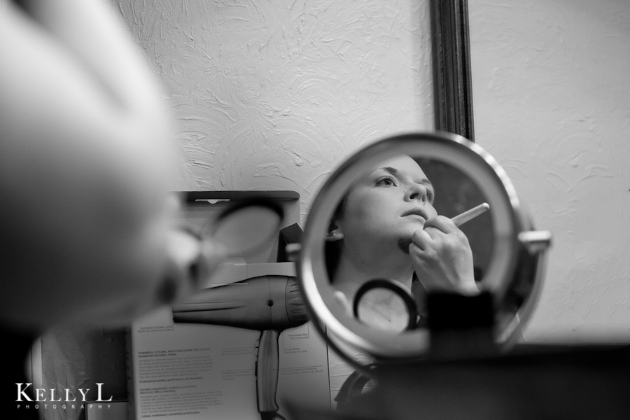 bride getting makeup done for wedding