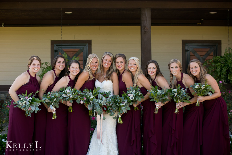 bride with her bridesmaids wearing dark red