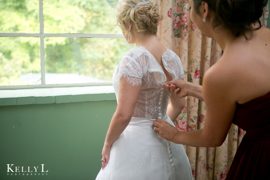 bride getting ready at millstone at adam's pond